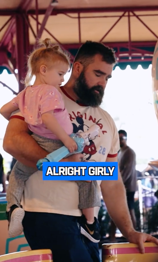 Jason Kelce boarding the teacup ride with his daughter. 